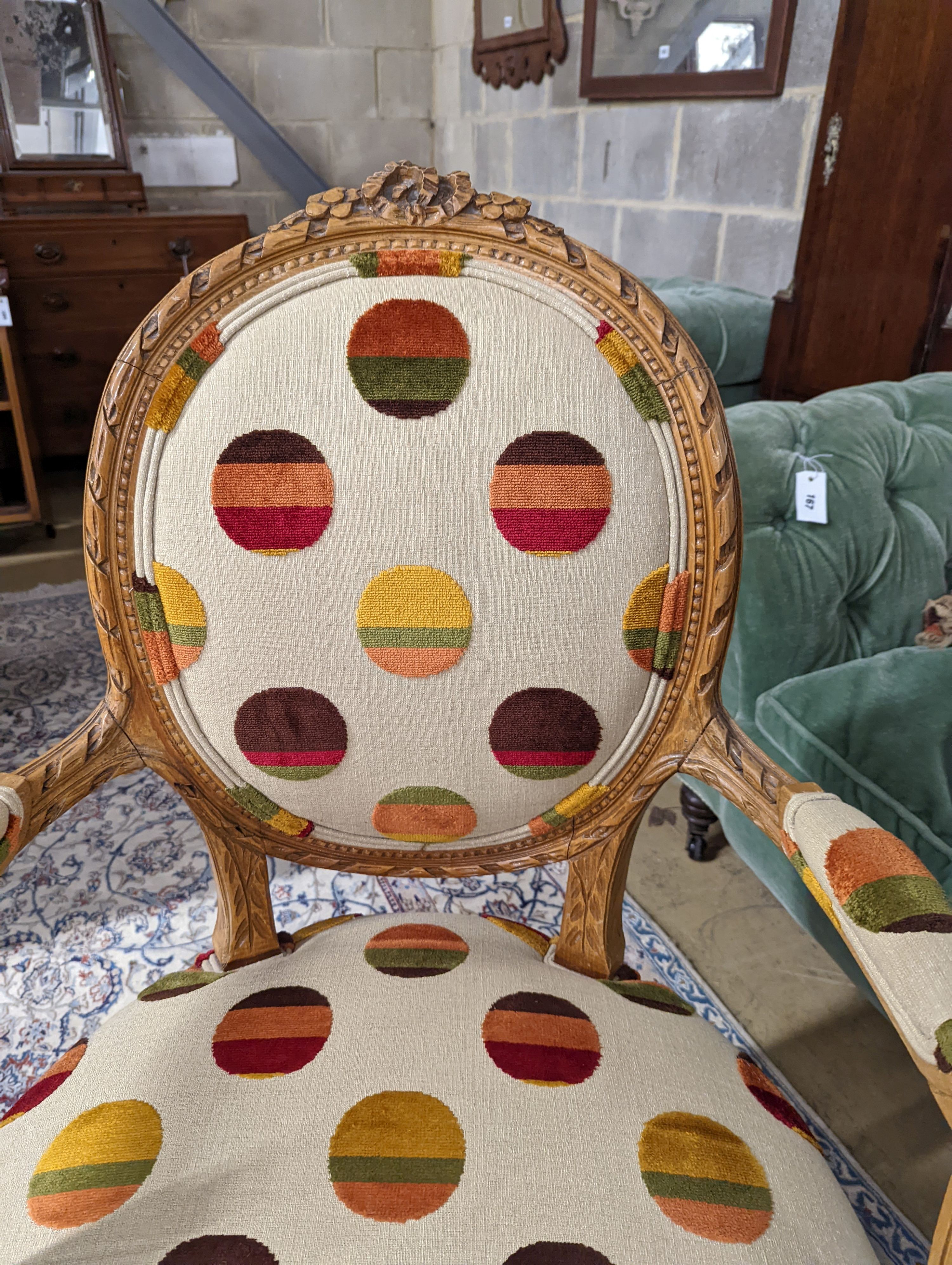 A Louis XVI style carved beech upholstered open armchair, width 62cm, depth 62cm, height 102cm